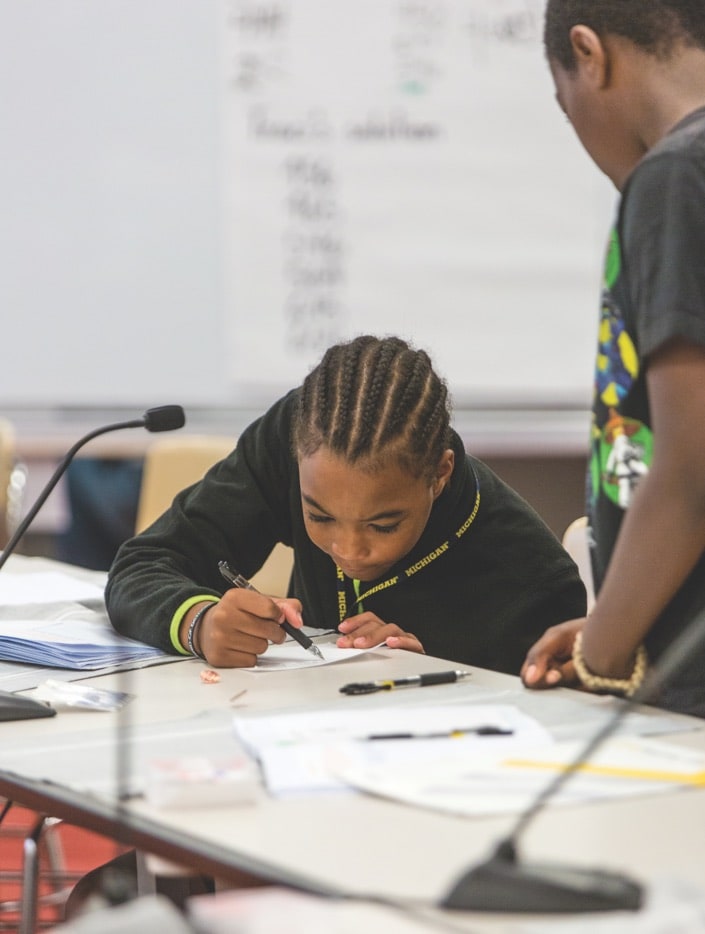 Two children working on a project at a desk
